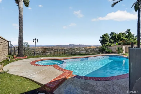 a view of a swimming pool with a lounge chair