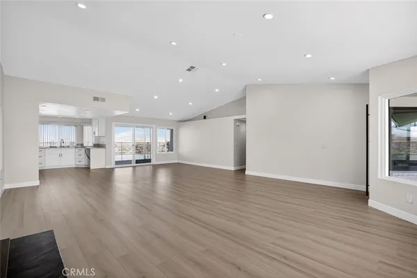 a view of kitchen with kitchen island and wooden floor