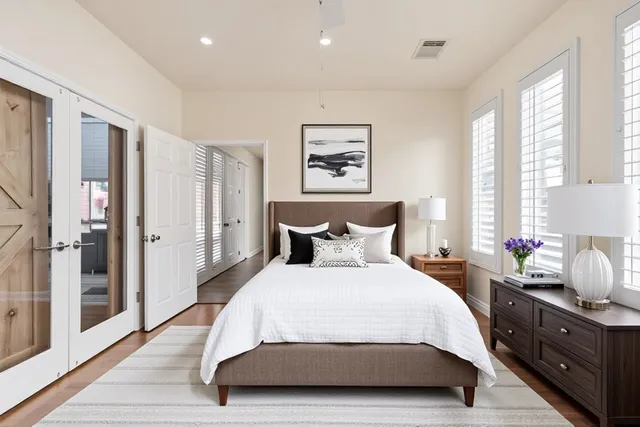 a kitchen with granite countertop a table chairs microwave and cabinets