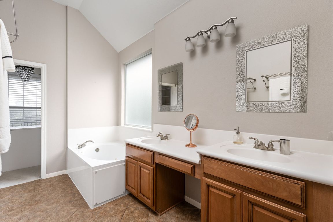 7109 Via Correto Drive Austin, TX 78749 - Photo 21 of 40 a bathroom with a tub sink and mirror