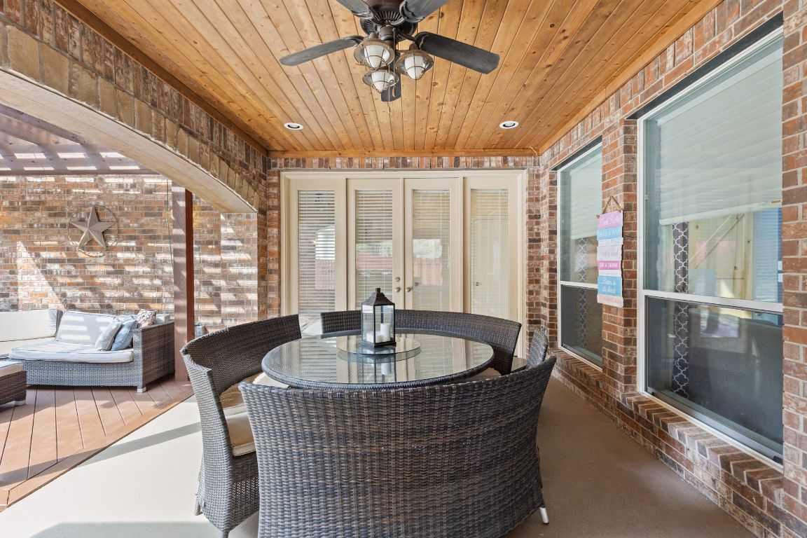7109 Via Correto Drive Austin, TX 78749 - Photo 34 of 40 a dining room with furniture a chandelier and glass door
