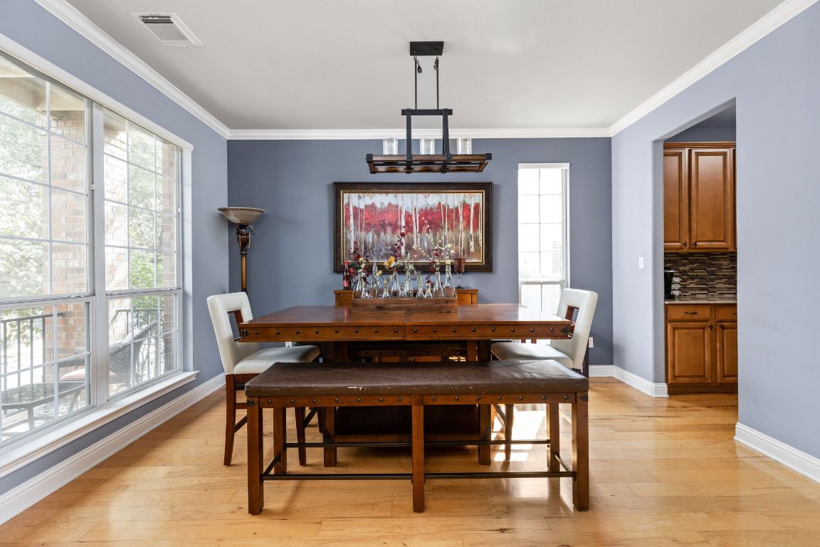 7109 Via Correto Drive Austin, TX 78749 - Photo 4 of 40 a view of a dining room with furniture window and wooden floor