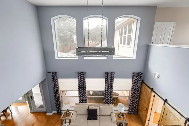 a kitchen with stainless steel appliances a dining table chairs microwave and sink