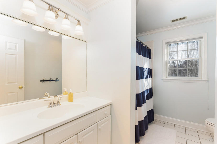 11 Revere Road Darien, CT 06820 - Photo 19 of 35 a bathroom with a sink and a mirror