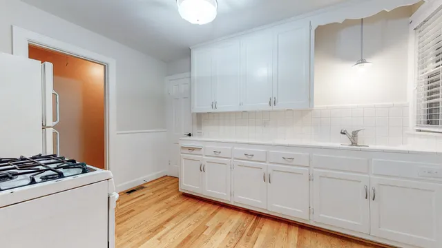 a kitchen with granite countertop a stove and a sink