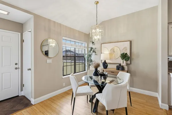 a view of a dining room with furniture wooden floor and chandelier