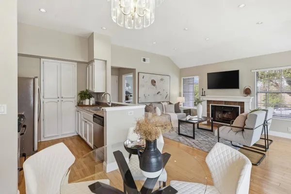 a living room with furniture a fireplace and a flat screen tv