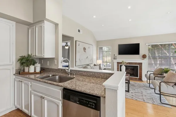 a spacious kitchen with granite countertop a granite counter tops and a fireplace