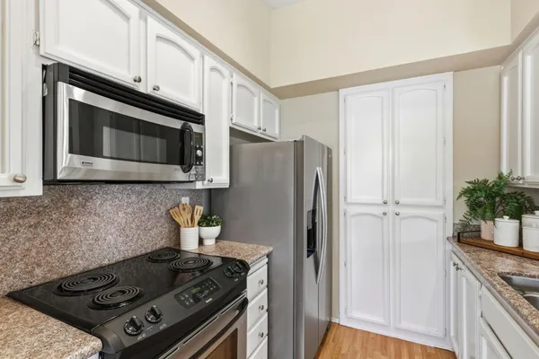 a kitchen with stainless steel appliances granite countertop a stove and a refrigerator