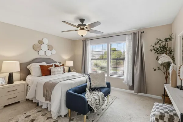a bedroom with a bed and ceiling fan