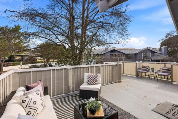 a view of a patio with iron fence