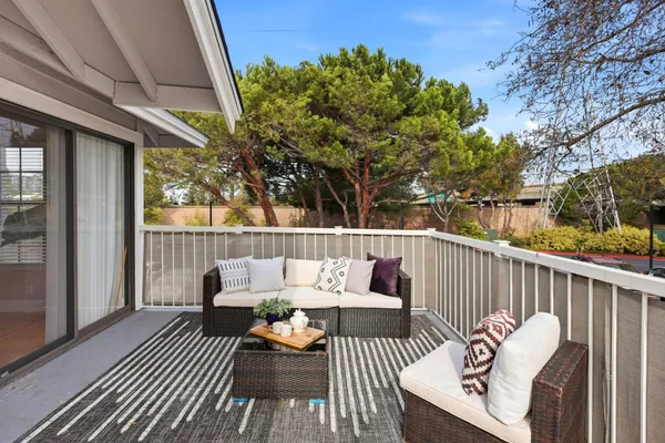 a balcony with wooden floor and furniture