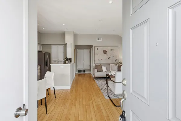 a view of a living room with furniture and wooden floor