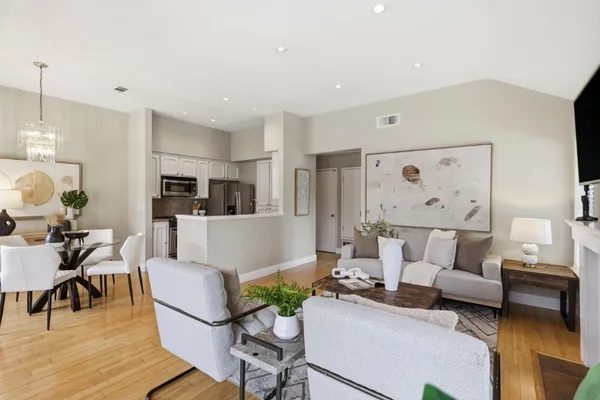 a living room with furniture and kitchen view
