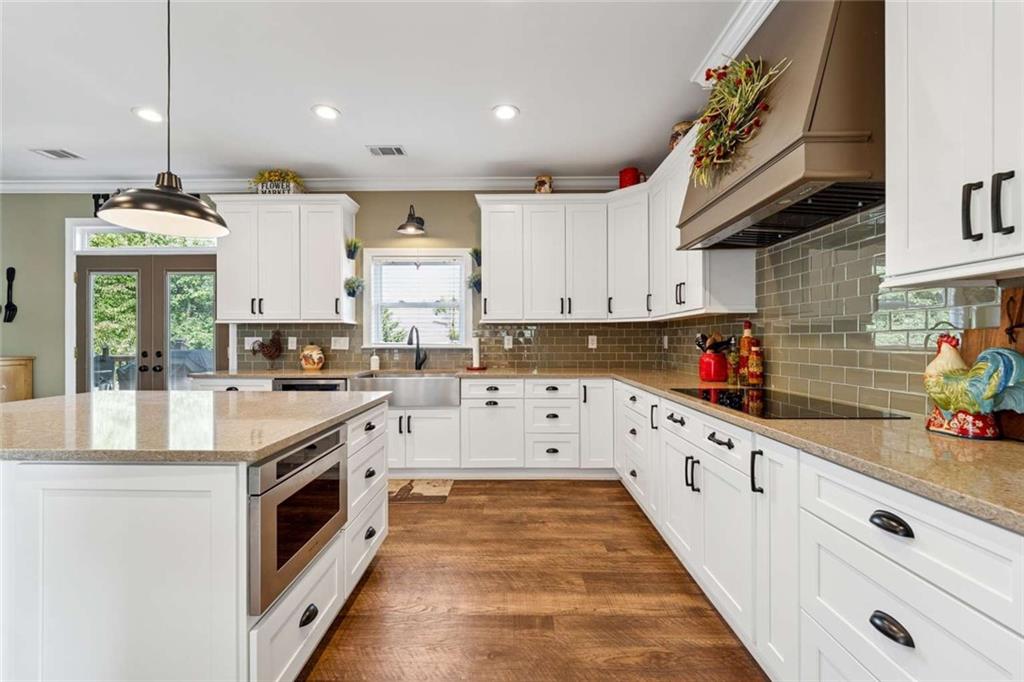 4510 Trailmaster Circle Cumming, GA 30028 - Photo 11 of 49 a kitchen with granite countertop white cabinets and white appliances