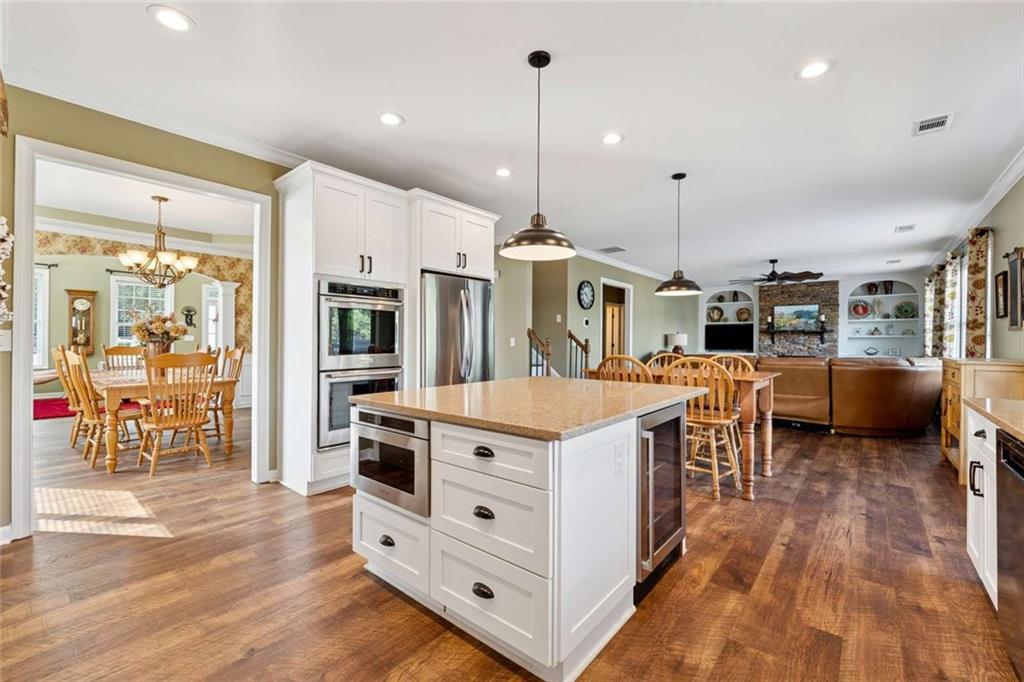 4510 Trailmaster Circle Cumming, GA 30028 - Photo 12 of 49 a large kitchen with stainless steel appliances kitchen island granite countertop a large counter top and wooden floors