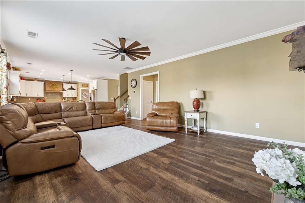 4510 Trailmaster Circle Cumming, GA 30028 - Photo 14 of 49 a living room with furniture and a wooden floor