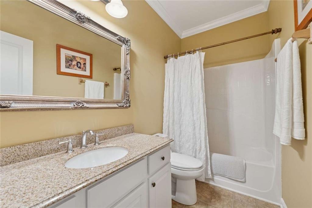 4510 Trailmaster Circle Cumming, GA 30028 - Photo 15 of 49 a bathroom with a granite countertop sink toilet and shower