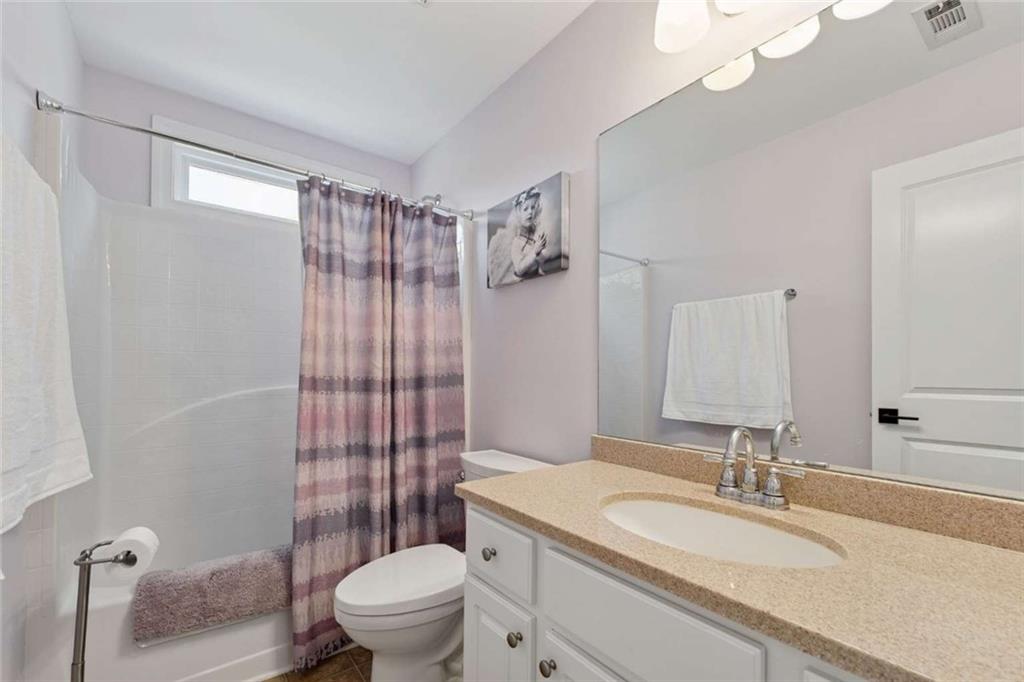 4510 Trailmaster Circle Cumming, GA 30028 - Photo 22 of 49 a bathroom with a sink a toilet a mirror and shower