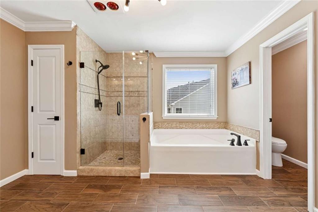 4510 Trailmaster Circle Cumming, GA 30028 - Photo 29 of 49 a bathroom with a bathtub and shower