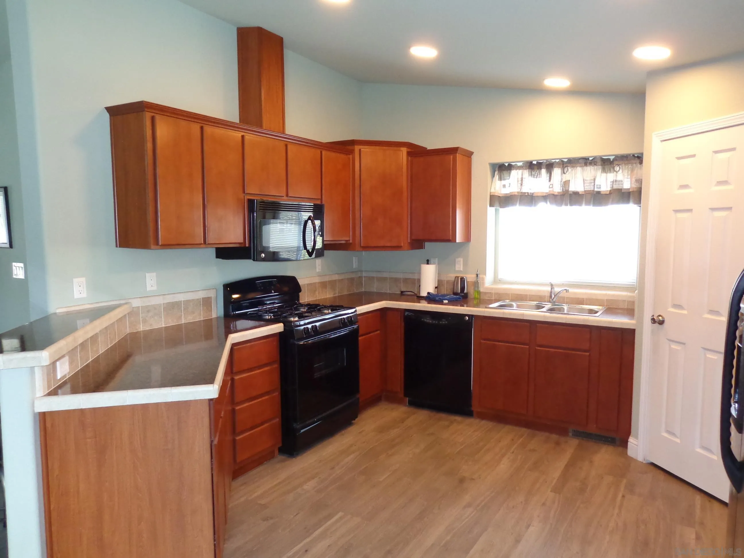 43 Havenview Lane Oceanside, CA 92056 - Photo 12 of 24 a kitchen with stainless steel appliances granite countertop a stove a sink and a refrigerator