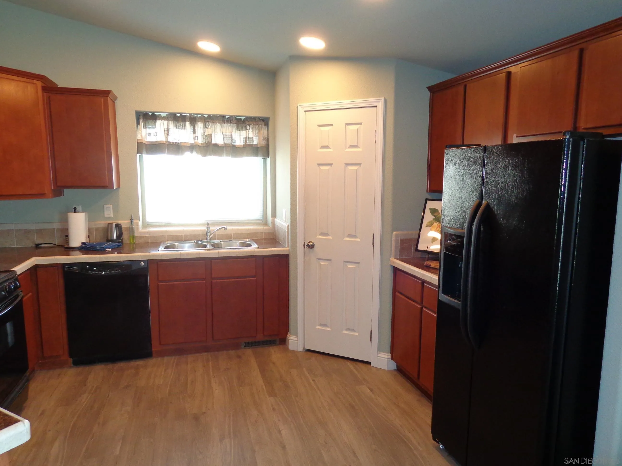 43 Havenview Lane Oceanside, CA 92056 - Photo 13 of 24 a kitchen with granite countertop a refrigerator and a sink