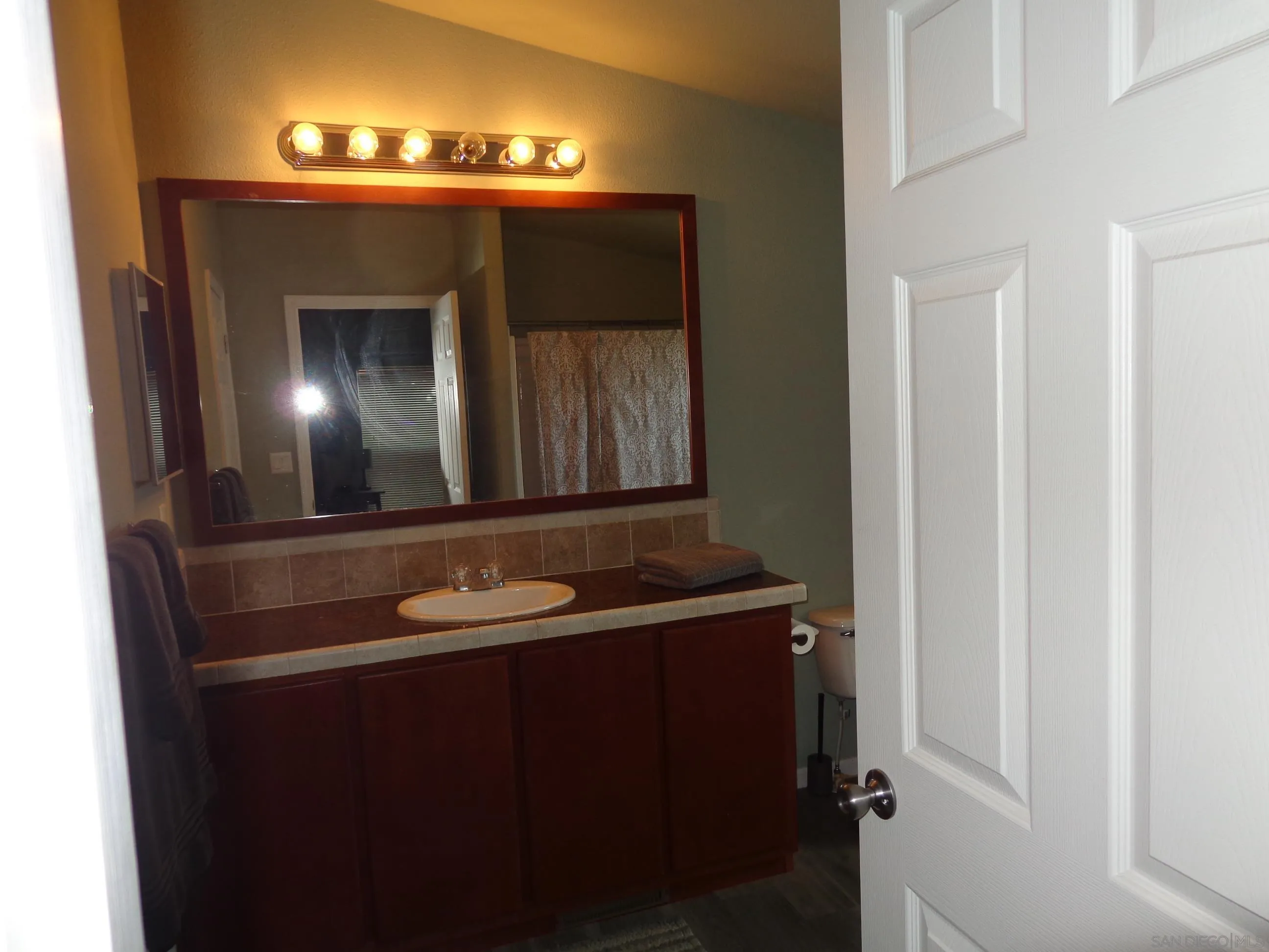 43 Havenview Lane Oceanside, CA 92056 - Photo 23 of 24 a bathroom with a sink and a mirror
