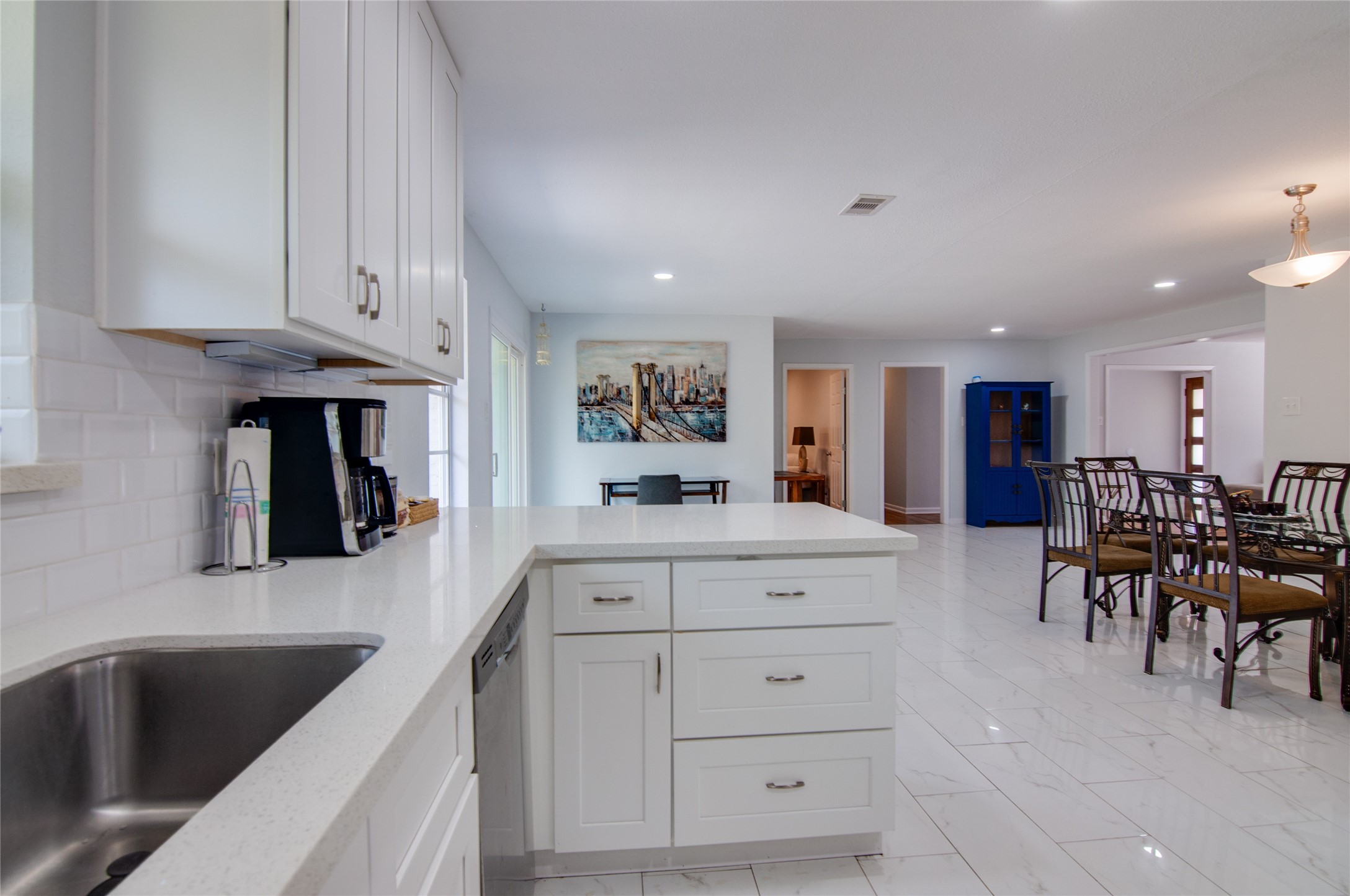 8922 Opelika Street Houston, TX 77080 - Photo 11 of 23 a kitchen with white cabinets and sink