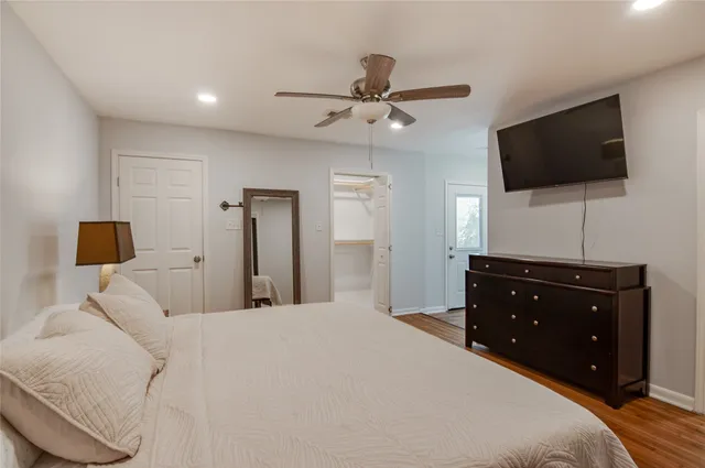 a bedroom with a bed and a flat screen tv