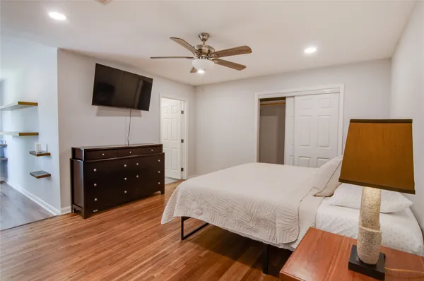 a bedroom with a bed and a flat screen tv