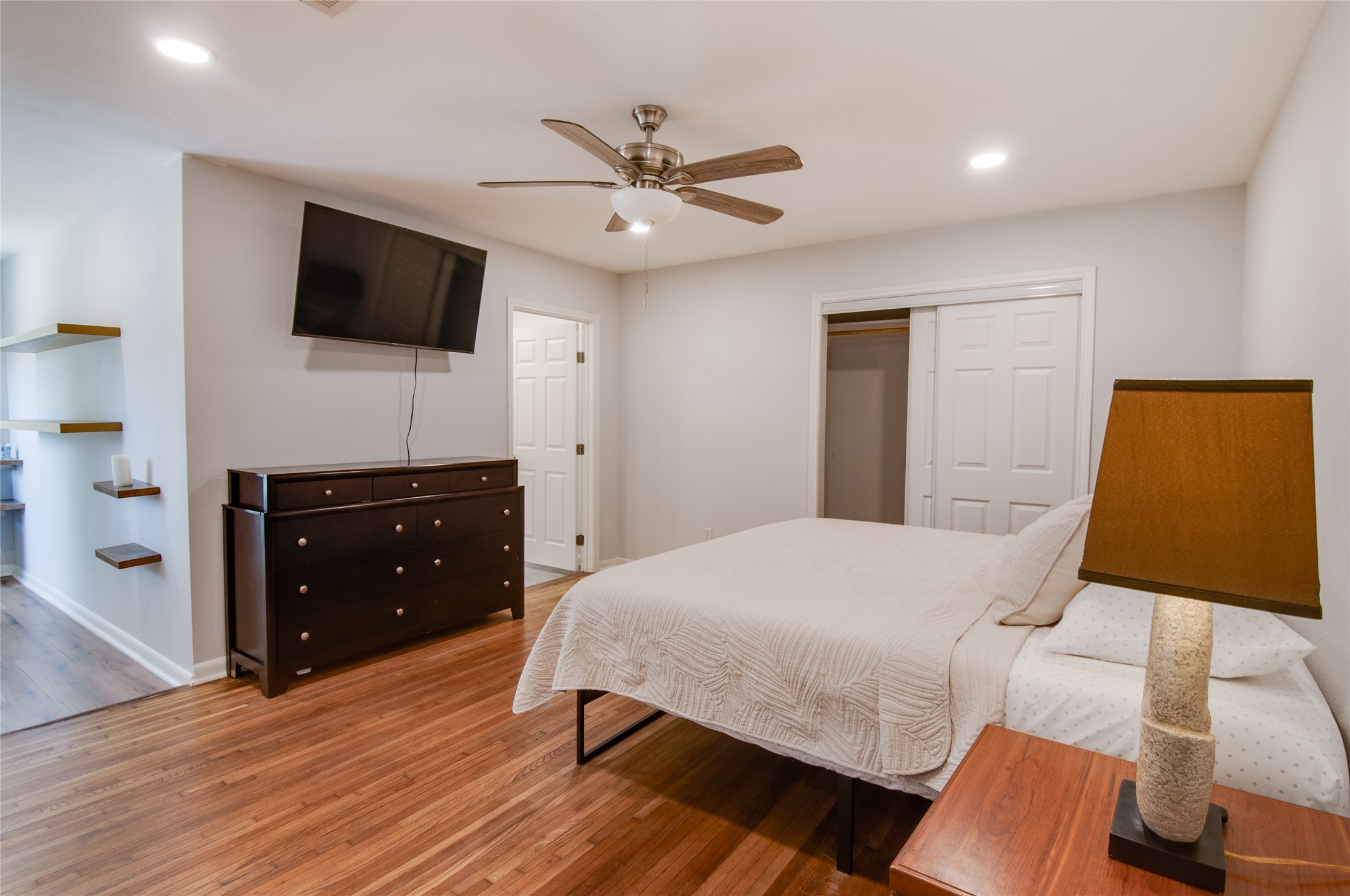 8922 Opelika Street Houston, TX 77080 - Photo 13 of 23 a bedroom with a bed and a flat screen tv