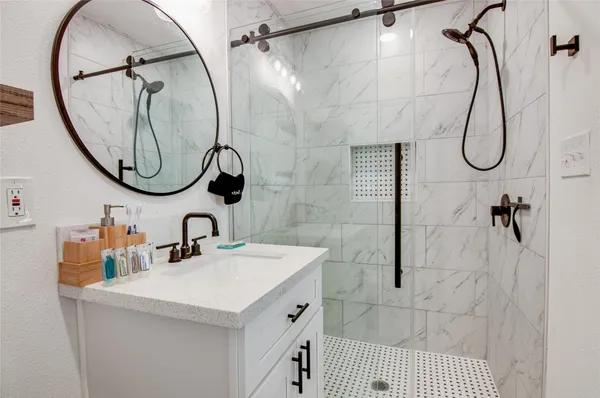 a bathroom with a sink vanity and a mirror
