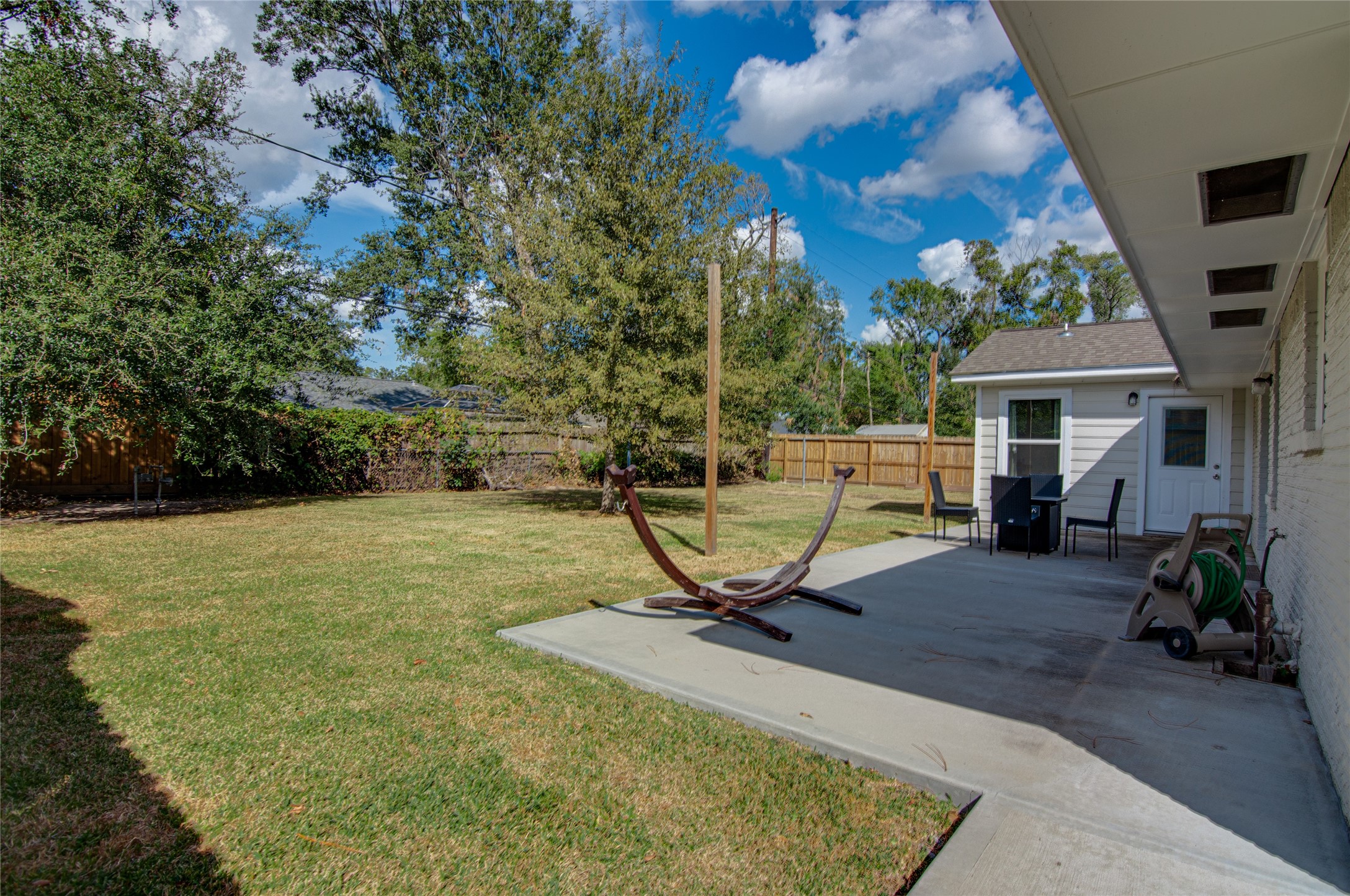 8922 Opelika Street Houston, TX 77080 - Photo 23 of 23 a view of a backyard with chairs and a fire pit