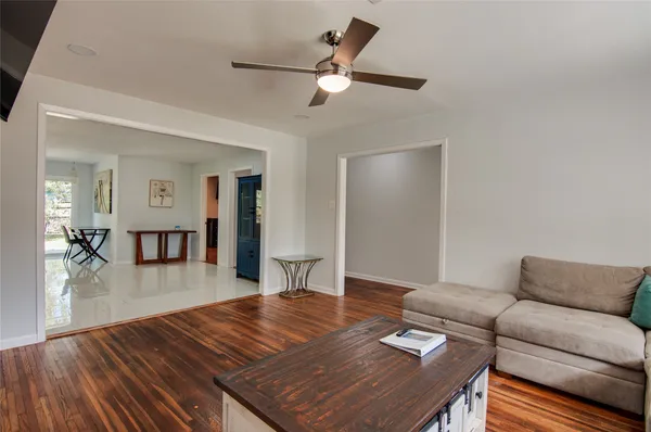 a living room with furniture and wooden floor