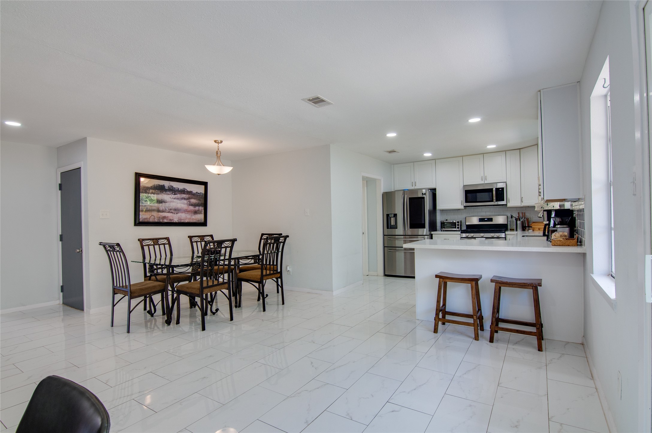 8922 Opelika Street Houston, TX 77080 - Photo 9 of 23 a open kitchen with cabinets table and chairs