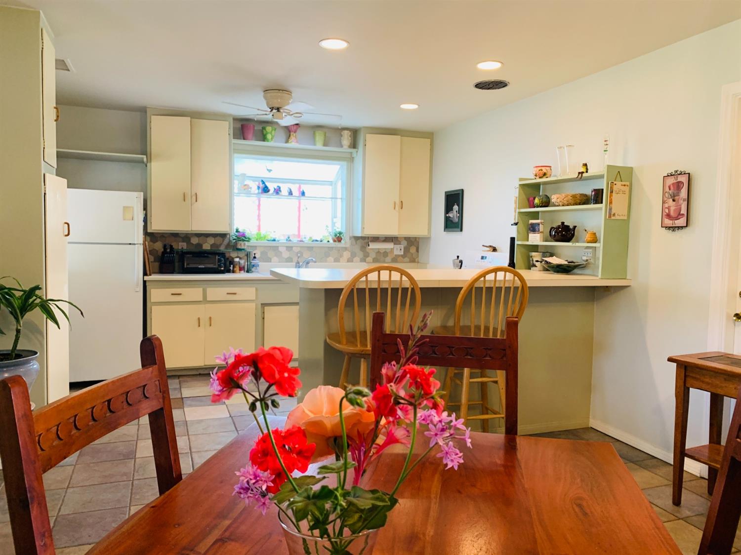 90 Rio Via Oak View, CA 93022 - Photo 3 of 42 a kitchen with stainless steel appliances kitchen island granite countertop a refrigerator a stove a sink and white cabinets with wooden floor
