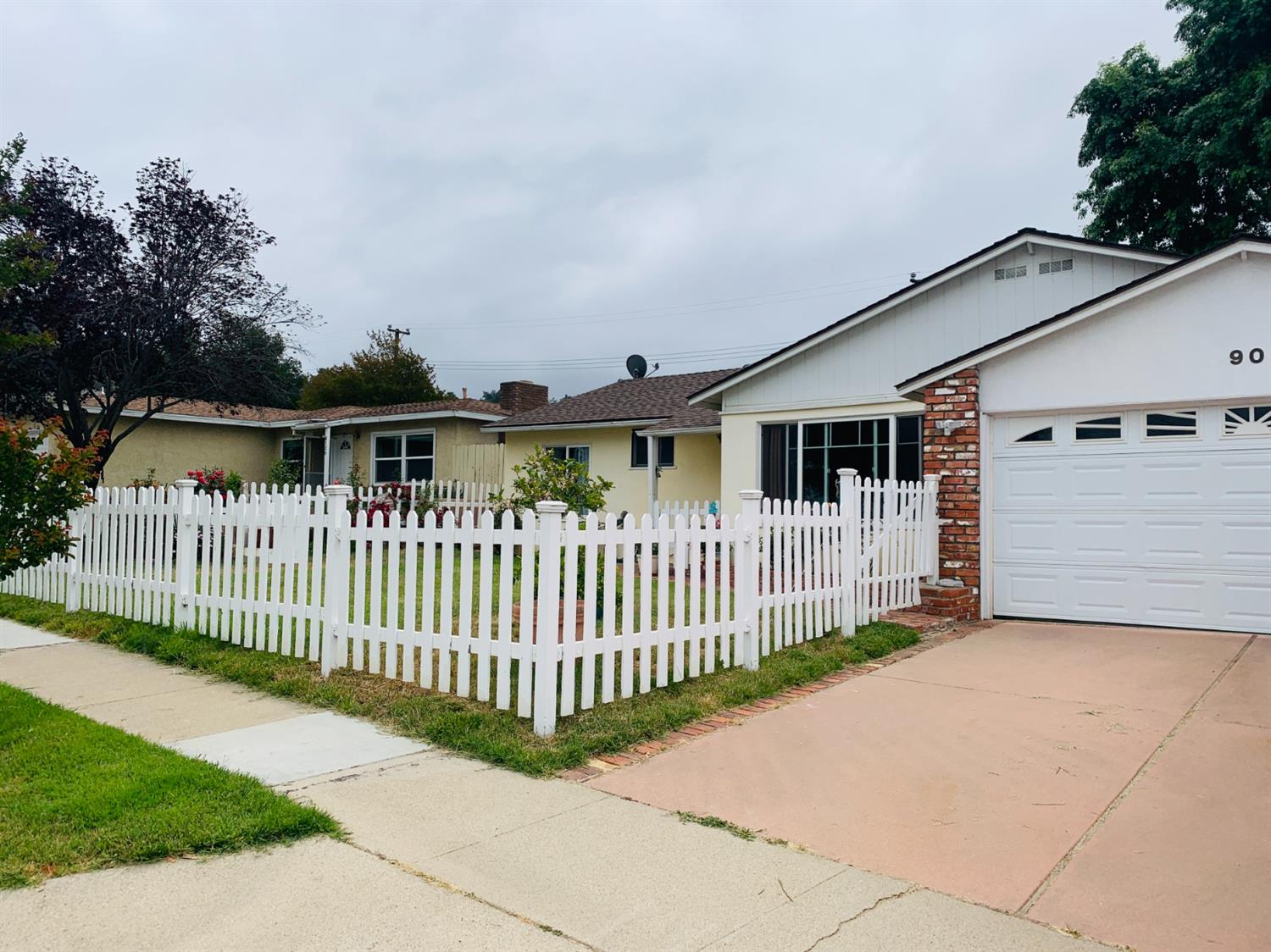 90 Rio Via Oak View, CA 93022 - Photo 40 of 42 a view of a white house that has a small yard and fence