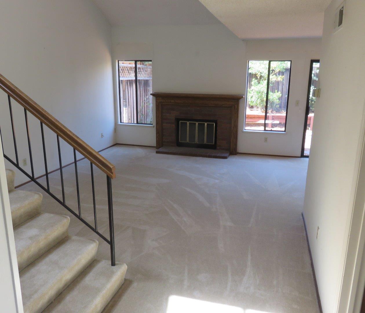 773 Superior Road Milpitas, CA 95035 - Photo 8 of 19 a view of an empty room with wooden floor fireplace and a window