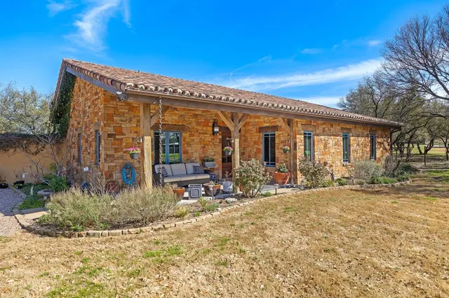 a view of a house with backyard porch and sitting area