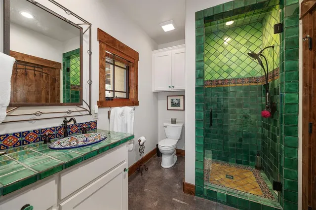 a bathroom with a sink toilet and shower