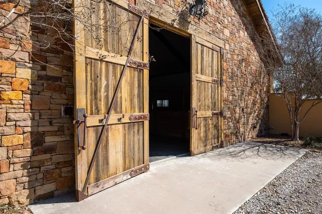a view of staircase with railing and white walls