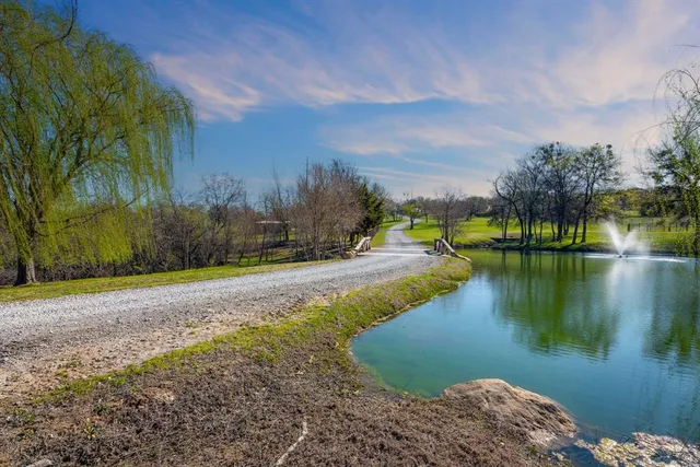 a view of a lake with houses in the back