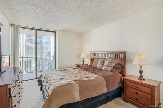 a bedroom with a bed and a night stand