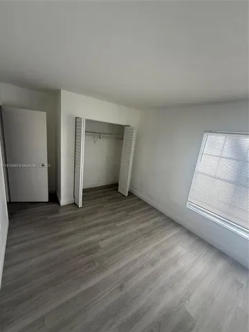 wooden floor and window in an empty room