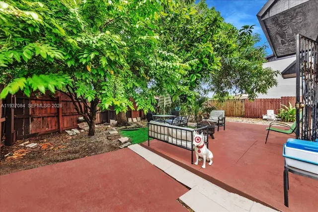 a view of a backyard with sitting area