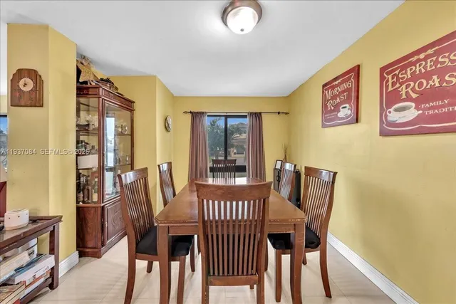 a view of a dining room with furniture and window