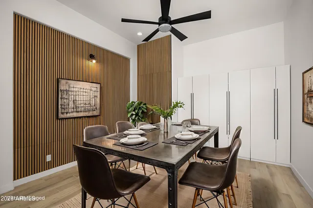a view of a room with gym equipment and a chandelier