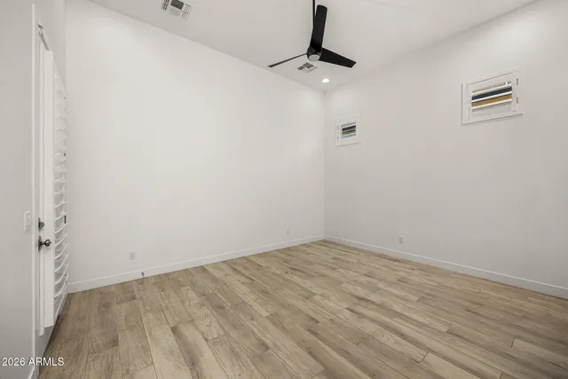 a bedroom with bed and a potted plant