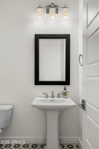 a bathroom with a toilet a sink and glass door