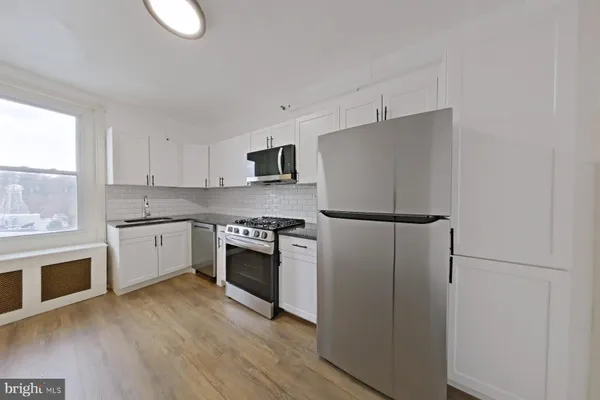 a kitchen with a refrigerator stove and microwave